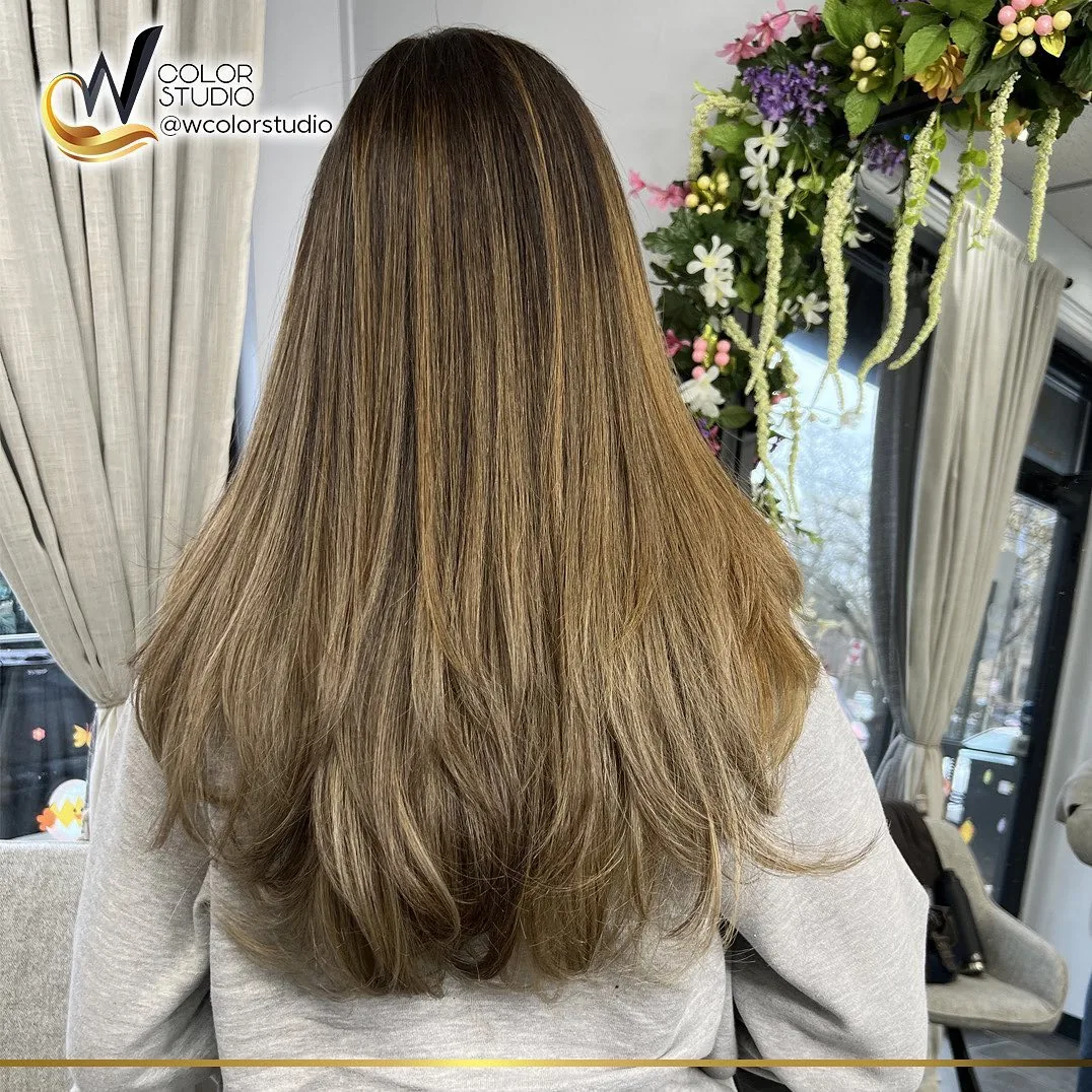 Soft golden blonde balayage with loose curls