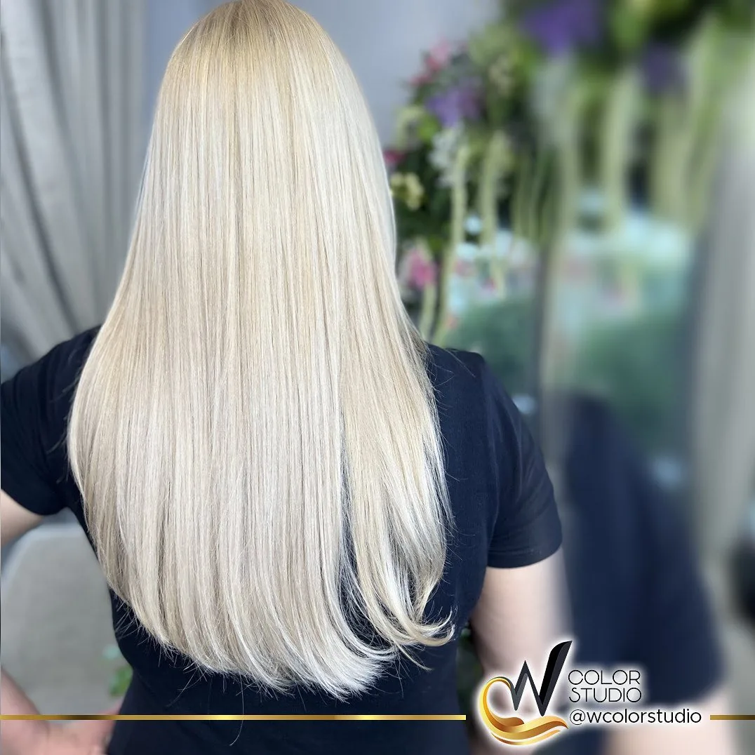 Long platinum blonde hair seen from the back at W Color Studio