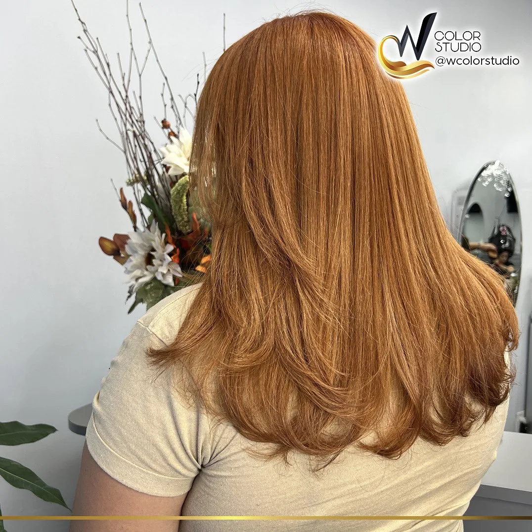 Warm caramel copper color on long layered hair