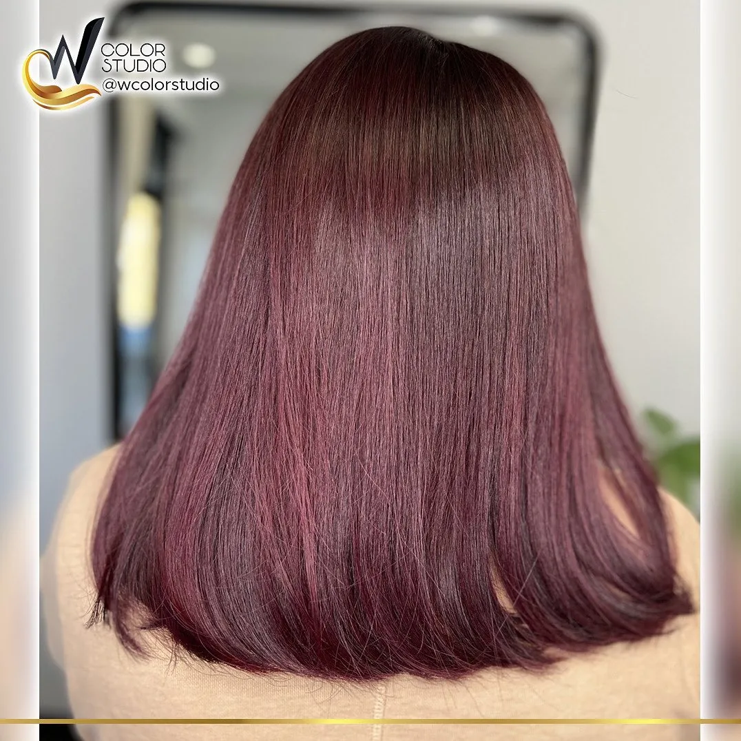 Soft violet red color on shoulder-length hair